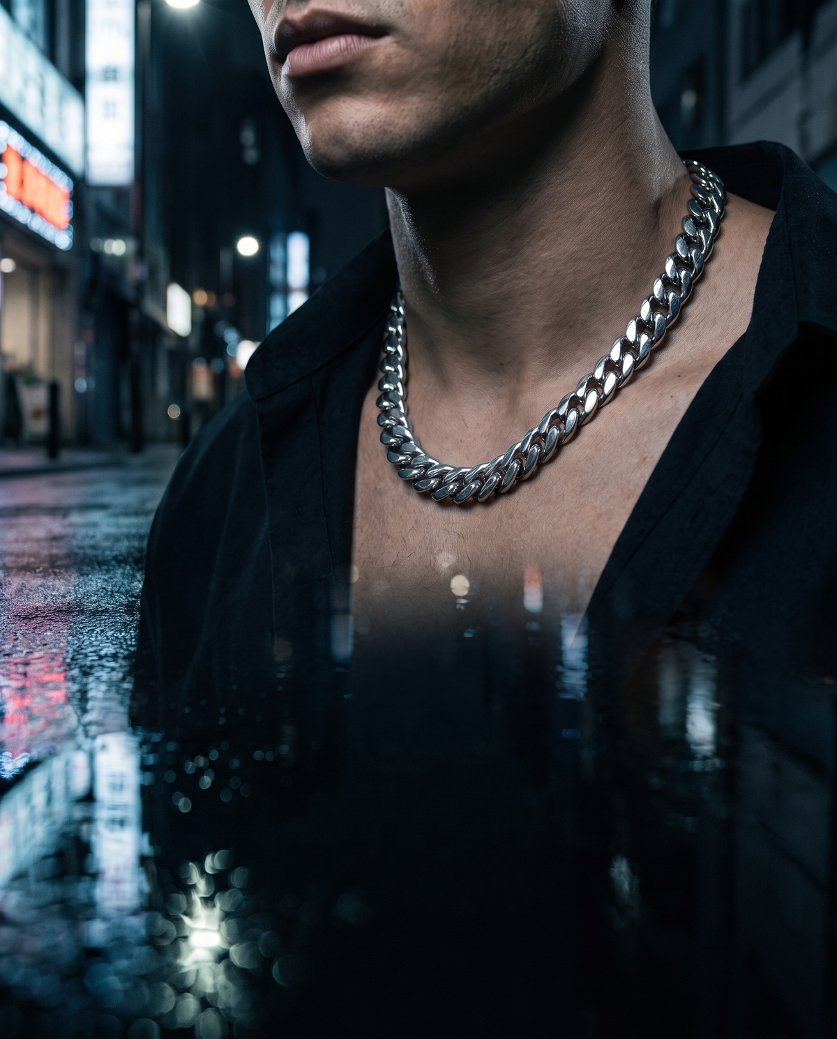 Silver Cuban link chain worn at the collarbone
